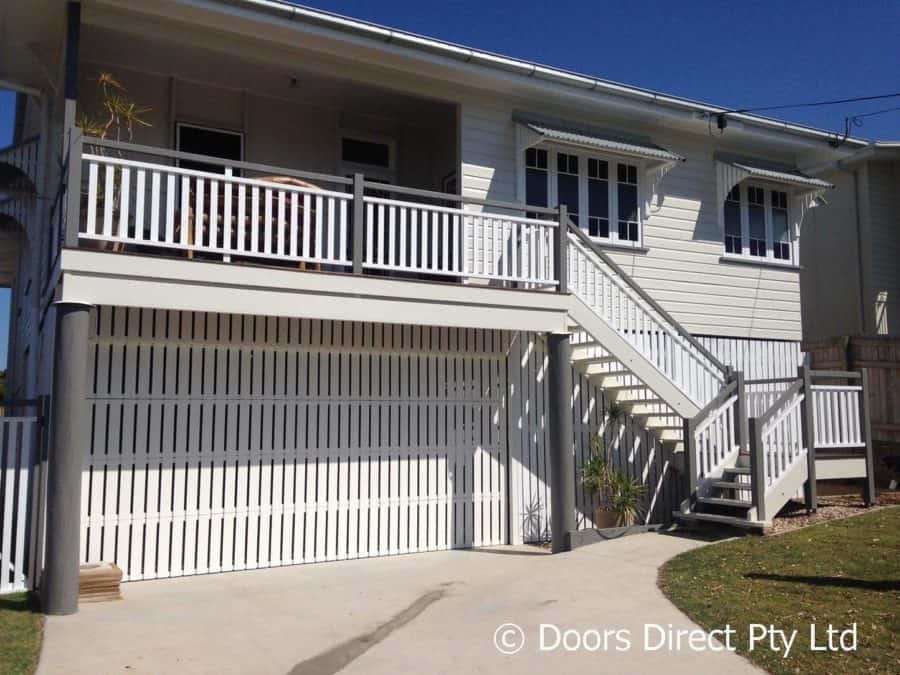 Custom made vertical aluminium sectional door with matching head panel